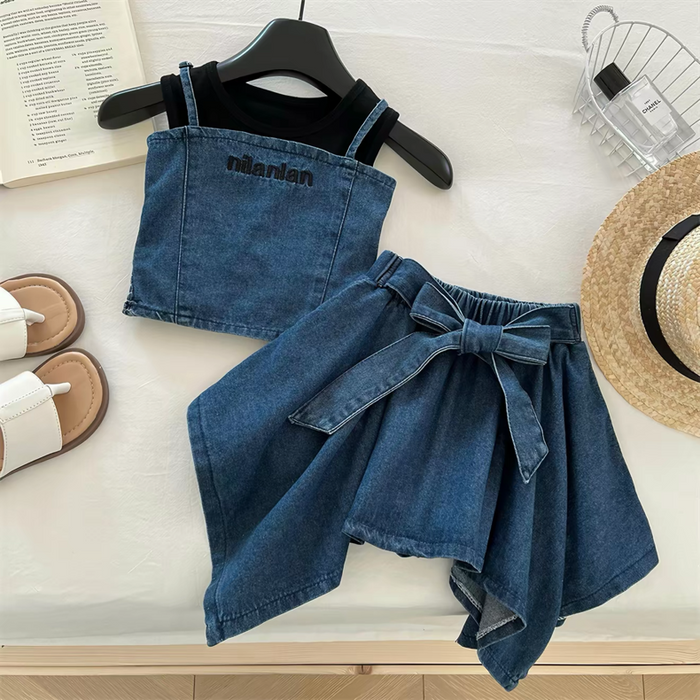 Denim top and skirt set with hanger, sandals, and hat on a light surface