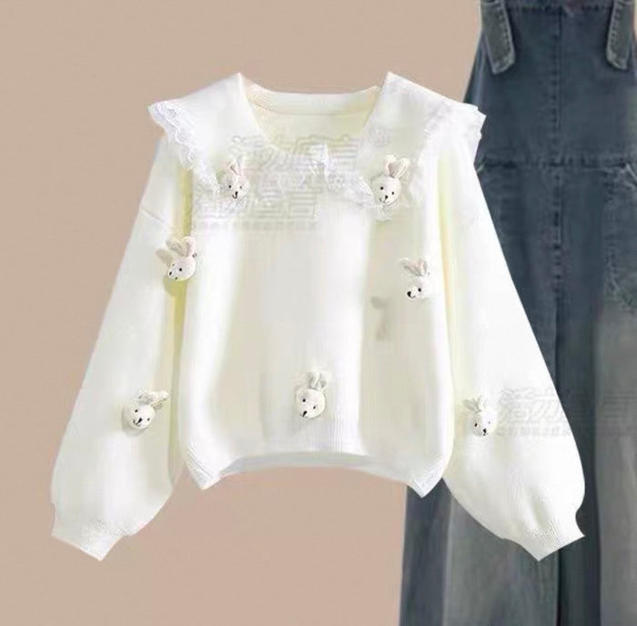 White blouse with floral embellishments on a beige background