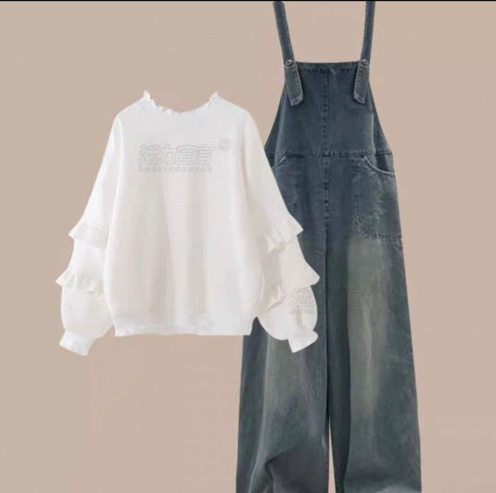 White blouse with ruffled sleeves and denim overalls on a beige background