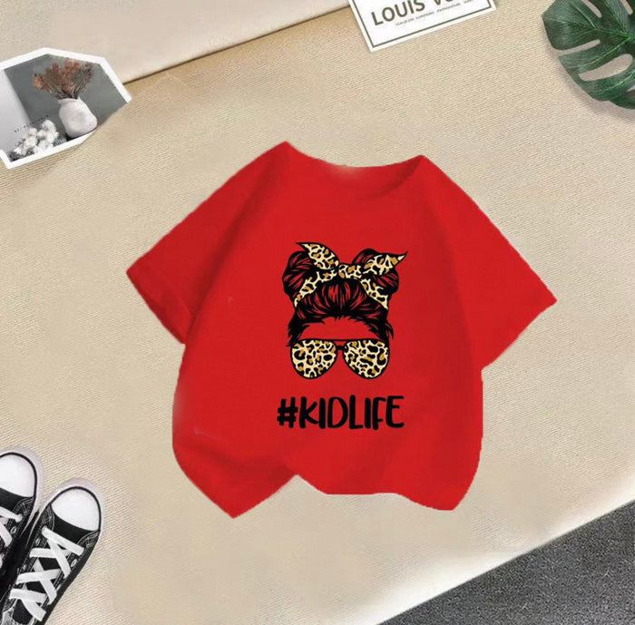 Red t-shirt with '#KIDLIFE' design on a beige surface
