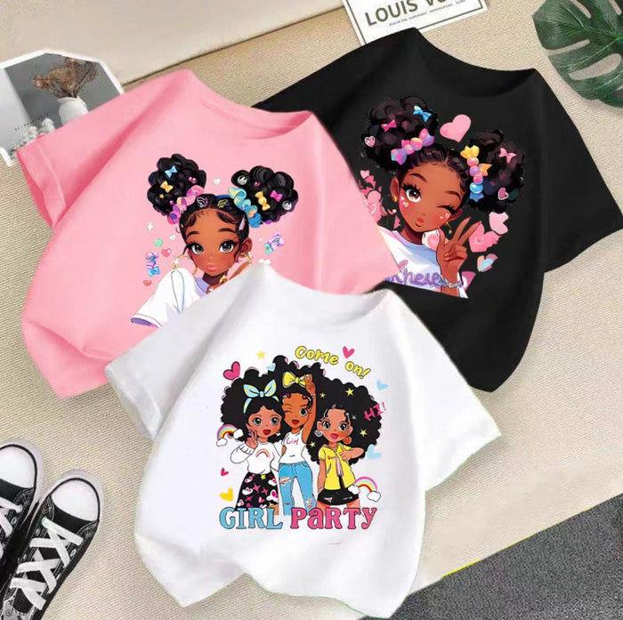 Three t-shirts with cartoon characters and text on a surface.