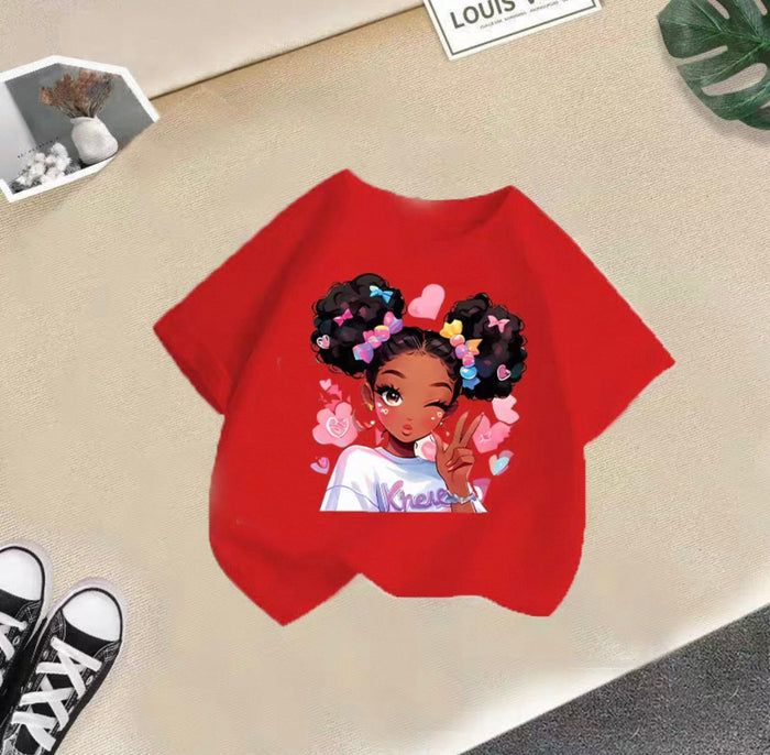 Red t-shirt with a graphic of a girl with flowers in her hair on a beige surface.