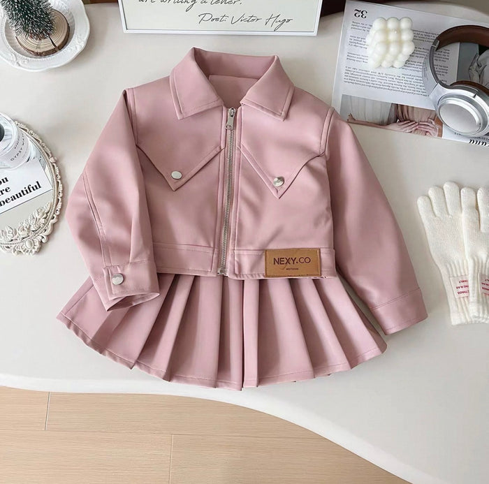 Pink jacket with a plaid skirt on a white surface, featuring the brand 'Nexy Co'.