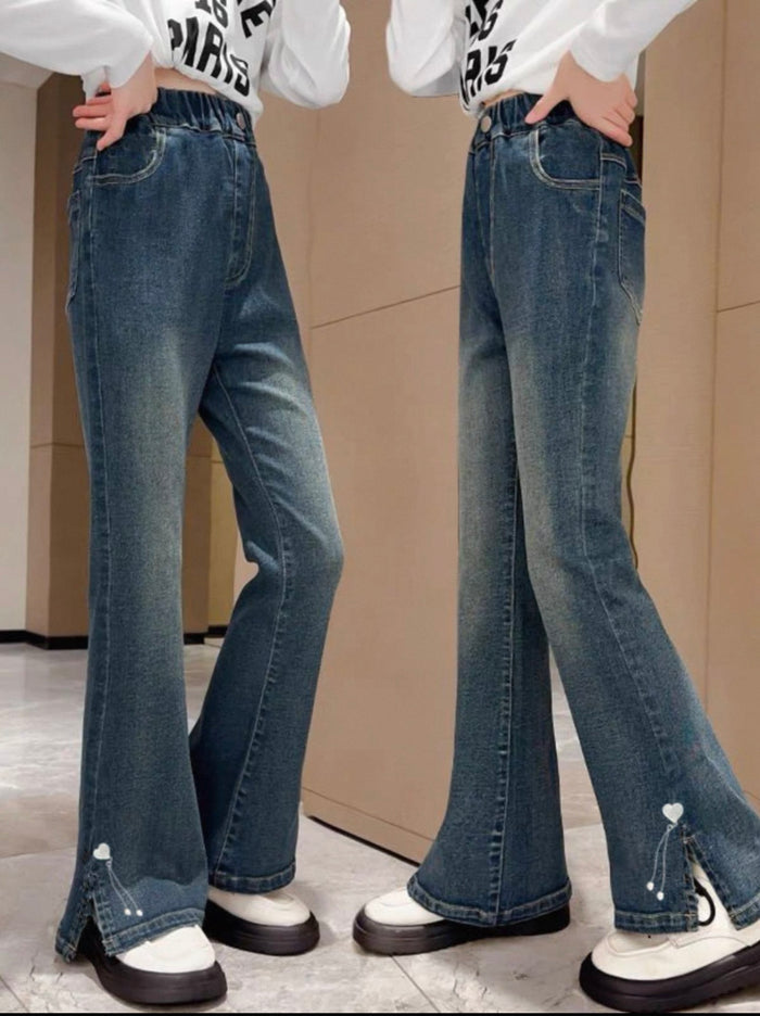 Pair of blue jeans worn by a person on a neutral background
