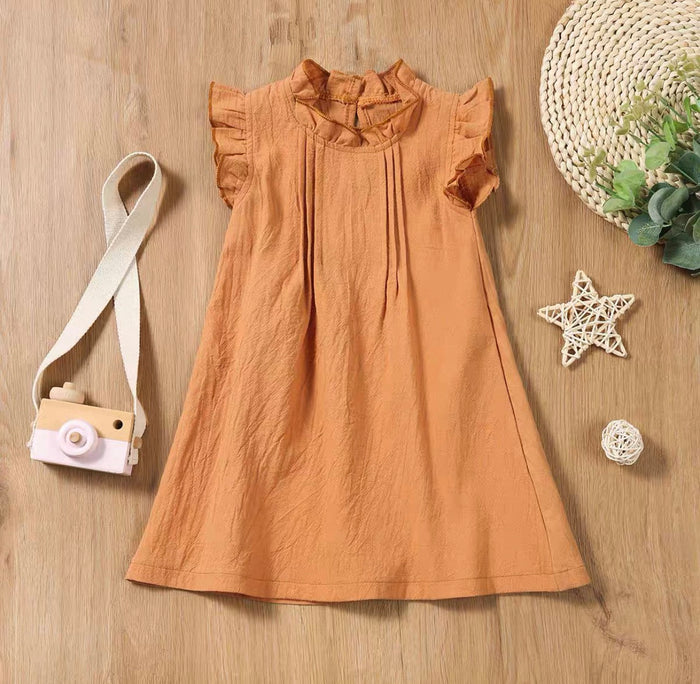 Brown dress on a wooden surface with decorative items