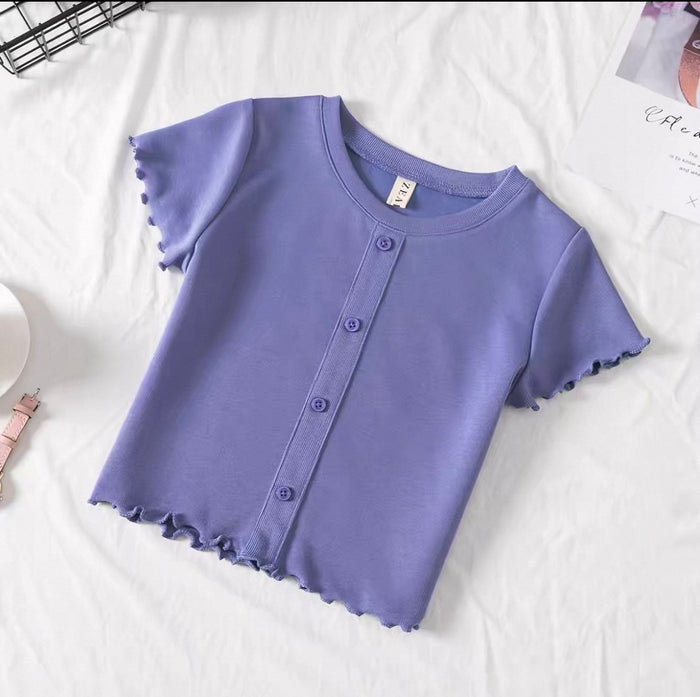 Purple short-sleeve shirt with button details on a white surface