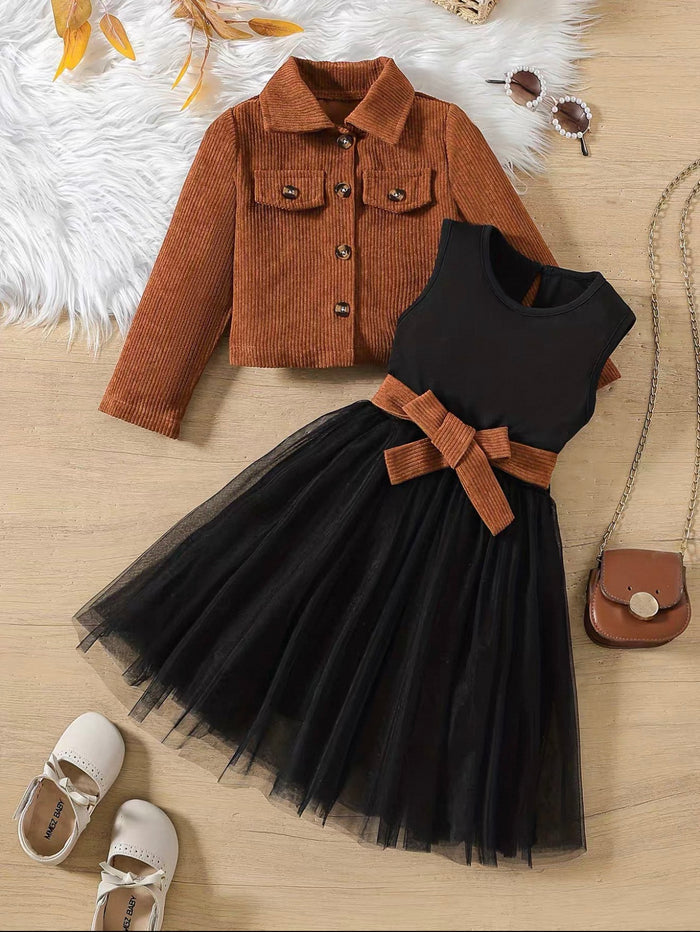 Black dress with brown belt and jacket on a wooden floor