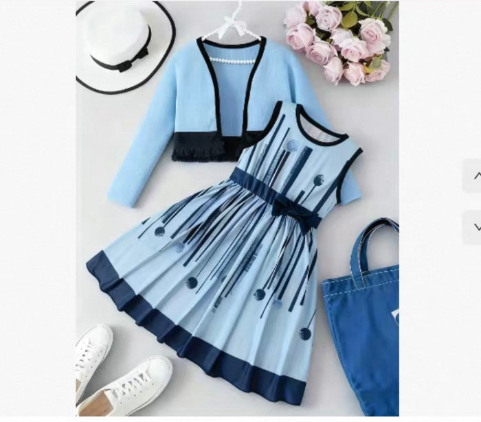 Blue dress with black accents, light blue cardigan, white sneakers, and a hat on a light gray background.