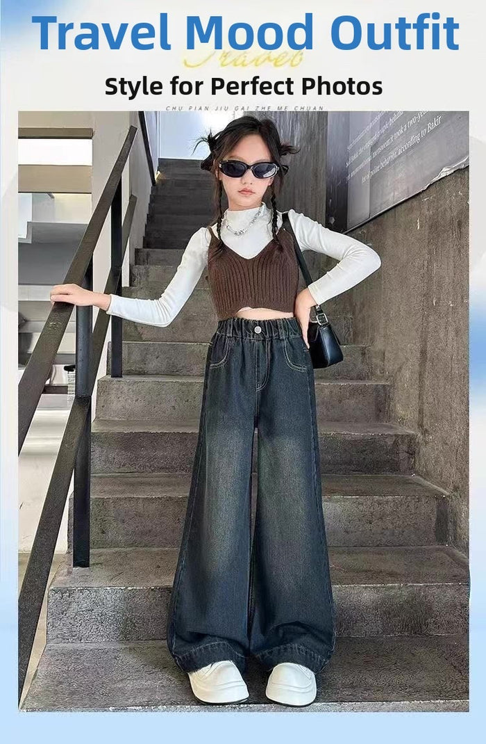 Person wearing a stylish outfit with a brown top and blue jeans standing on stairs.