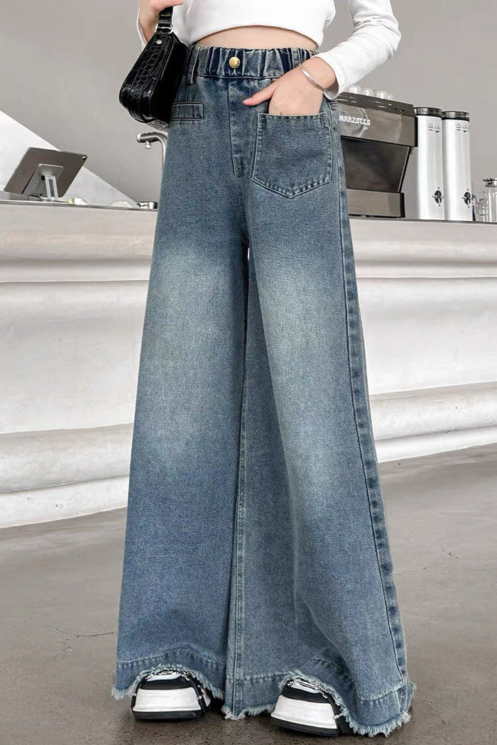 Person wearing wide-leg jeans in a casual setting