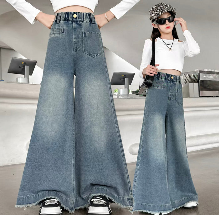Wide-leg jeans worn by a person in an indoor setting