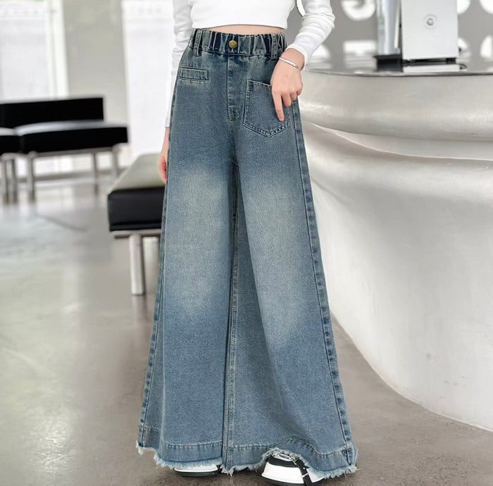 Person wearing wide-leg jeans in an indoor setting