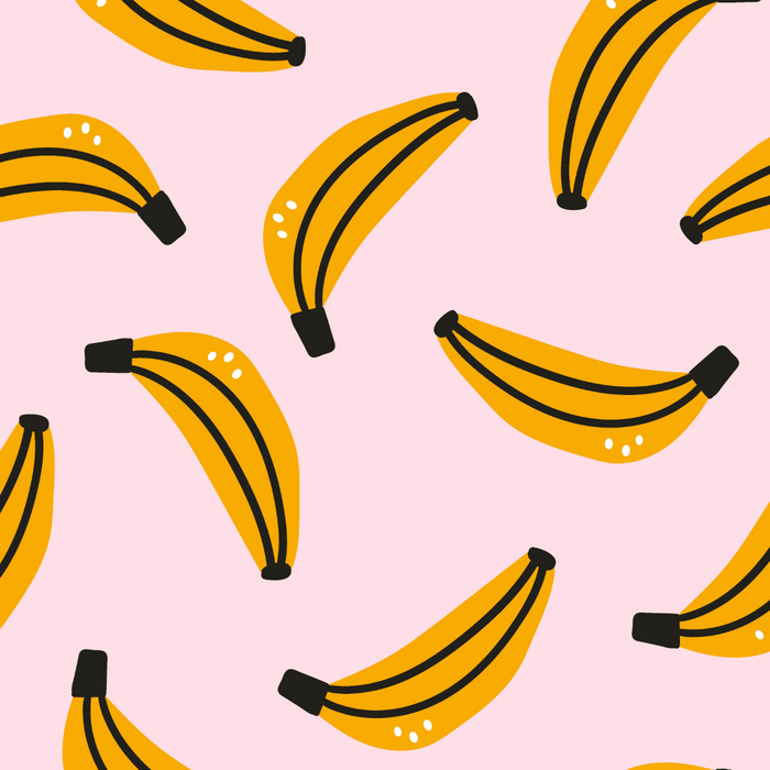 Pattern of yellow bananas with black stems on a pink background