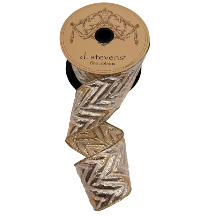 Gold and silver metallic chevron jacquard ribbon by d.stevens, 2.5 inches wide, cascading in loose folds from a spool.