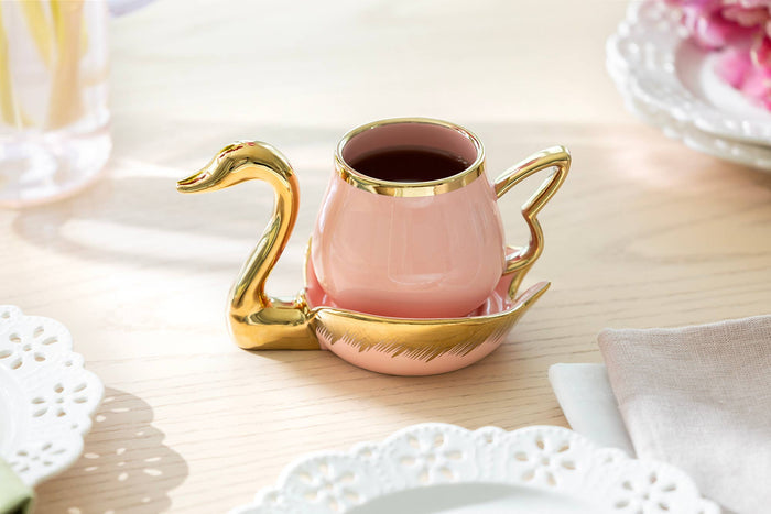 Pink fine porcelain tea cup and saucer with sculptural gold swan handle and metallic gold trim by Grace Teaware