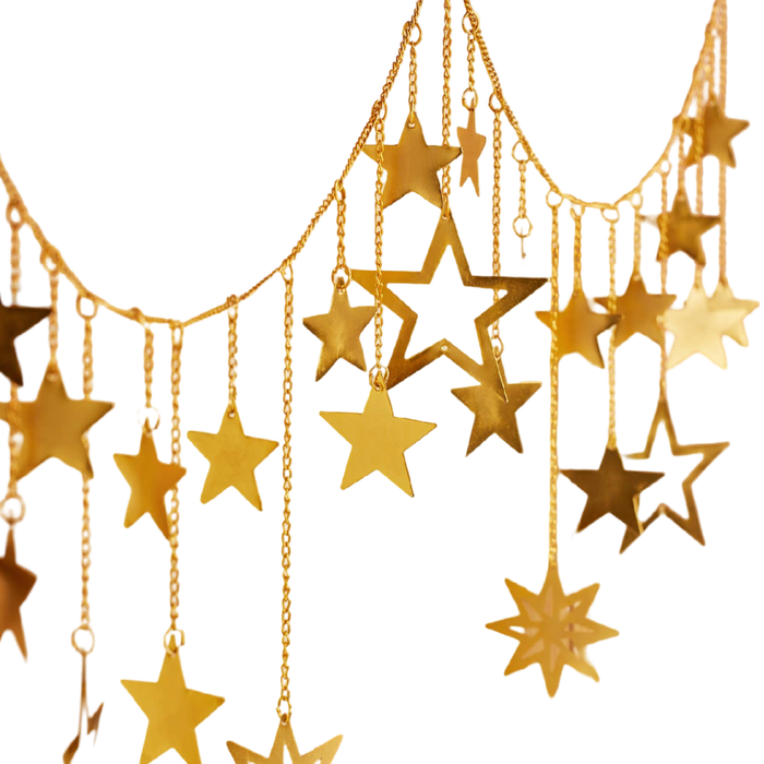 Handmade gold metal twinkling star chain garland with dangling stars for mantel and holiday decorating.