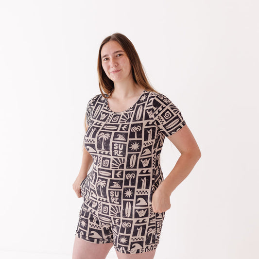 Woman wearing a black and white patterned romper on a white background