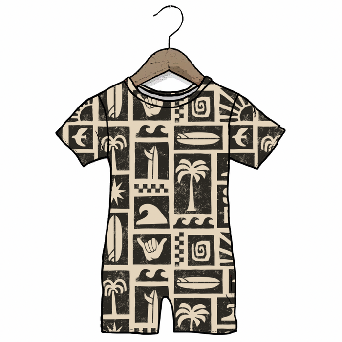 Children's romper with a pattern of palm trees, surfboards, and other symbols on a hanger against a white background.
