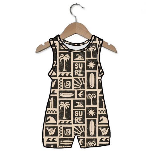 Children's sleeveless romper with surf-themed patterns on a hanger against a white background