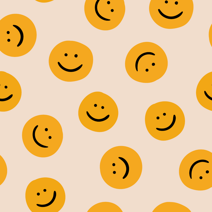 Pattern of yellow smiley faces on a beige background