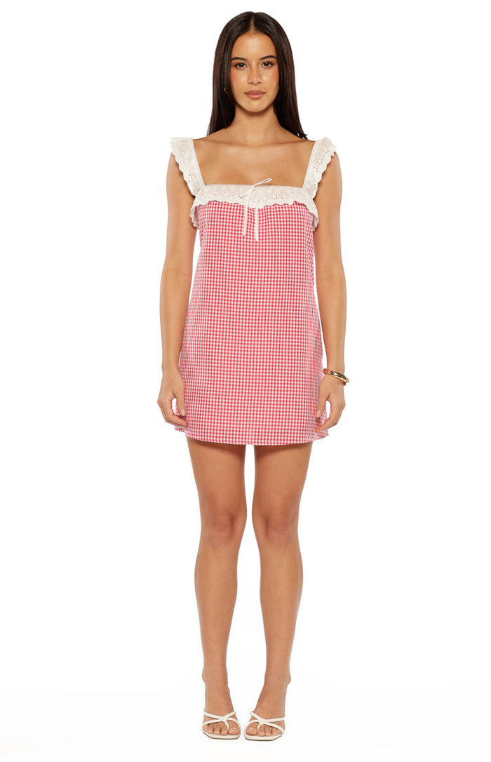 Red gingham mini dress with a square neckline, white lace trim on the straps, and a small tie detail at the bust