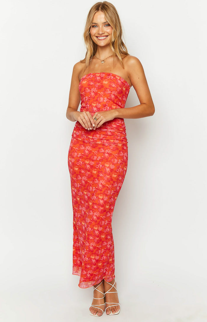 Front view of an orange and pink floral print strapless maxi dress with ruched side seams