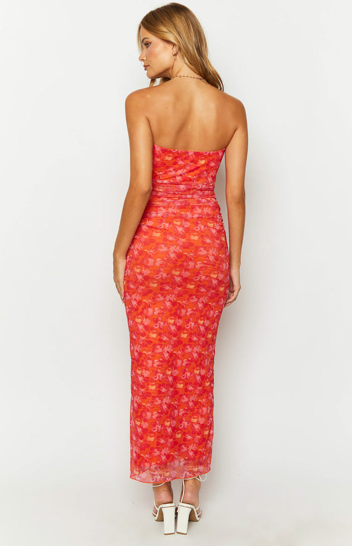 Rear view of an orange floral print strapless bodycon maxi dress with ruched waist detail