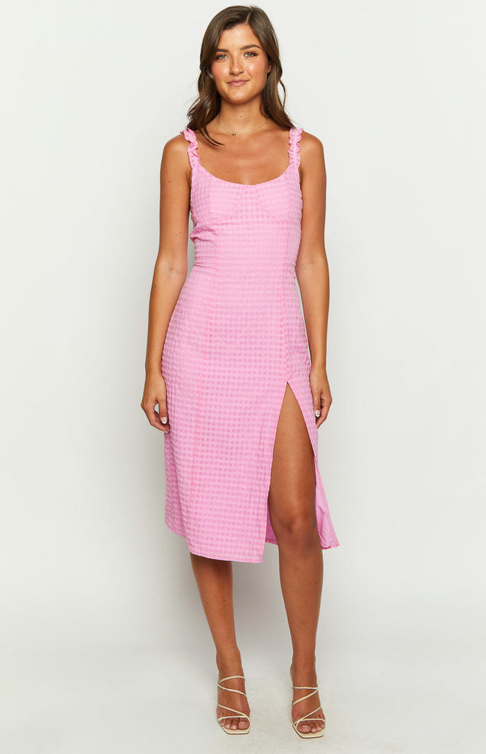 Front view of a pink gingham midi dress with a scoop neckline, ruffled shoulder straps, and a high side slit