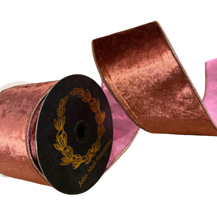 JME 4-inch mauve velvet ribbon arranged in broad loops beside a black spool, showing its contrasting pink dupion reverse.