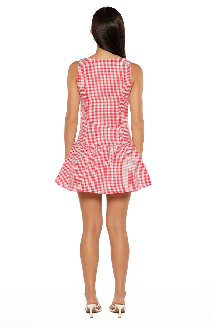 Rear view of a red and white gingham mini dress with a square back neckline and gathered tiered skirt
