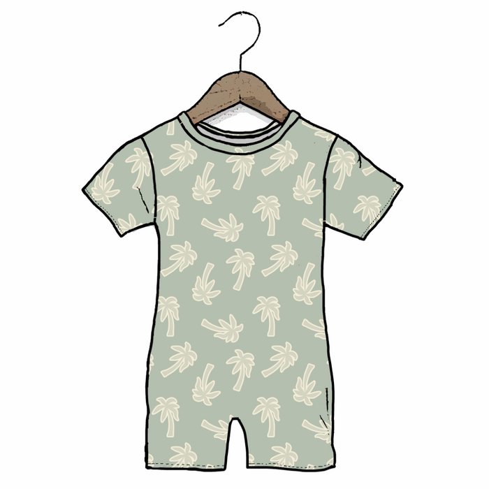 A short-sleeve baby romper in a pale sage green color, featuring an all-over cream palm tree pattern. It is shown hanging from a wooden hanger against a plain white background.