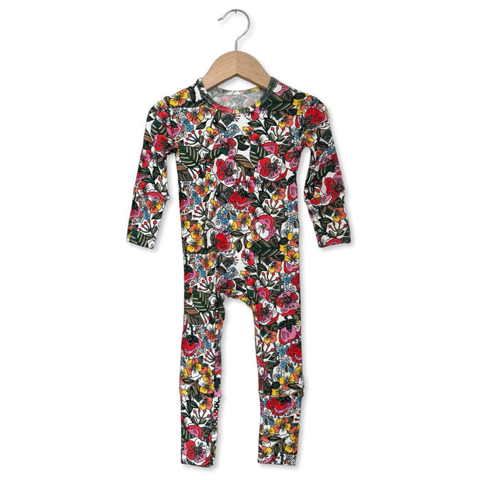 Floral patterned onesie on a hanger against a white background