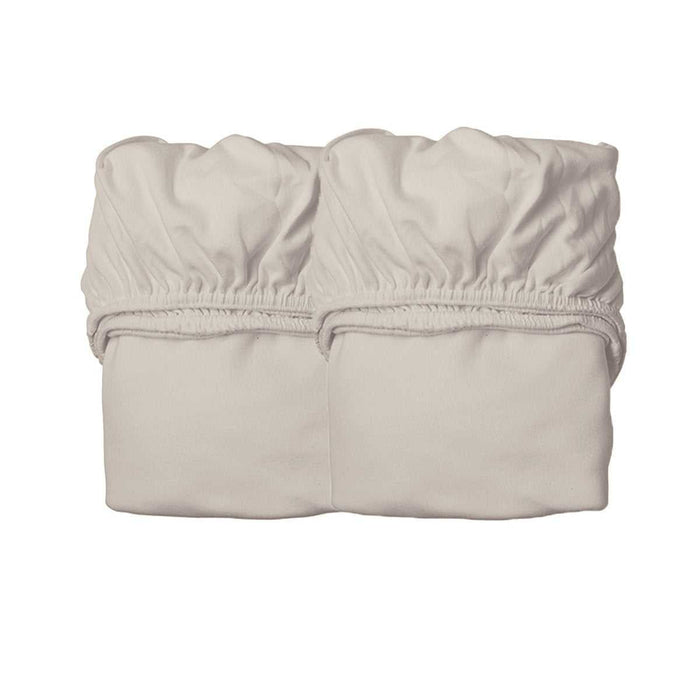 Two folded light-colored fitted sheets for Leander Junior Bed or Luna Cot Mattress