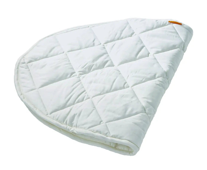 Quilted white changing pad on Leander Junior Bed Organic Mattress Protector for Toshi Baby