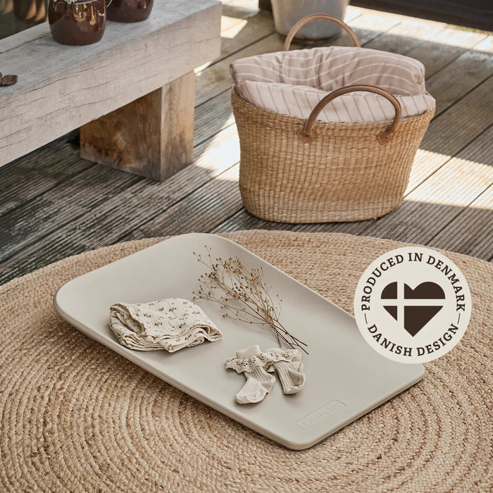 Rectangular tray with baby clothes on Leander Matty Mini Change Mat for Toshi Baby and baby strollers