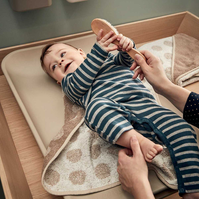 Baby on changing table using Toshi Baby with Leander Organic Matty Topper in organic cotton terry