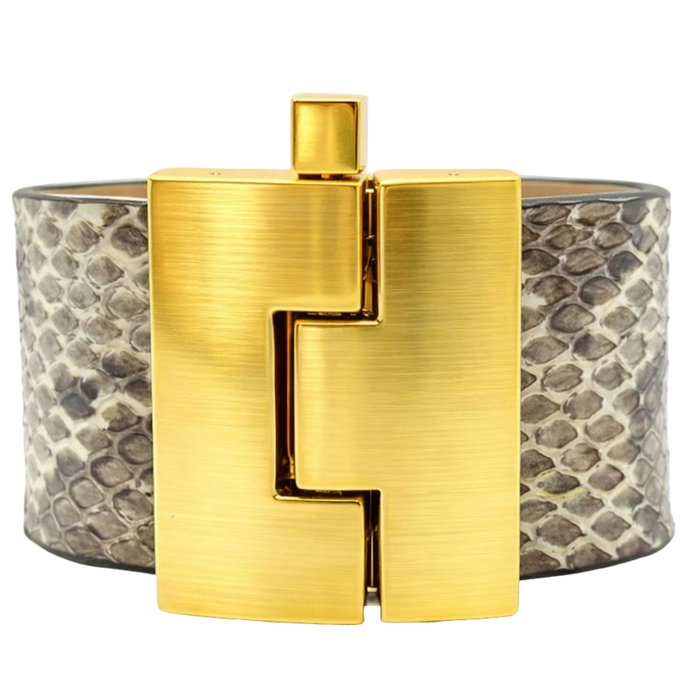Gold bracelet with a textured band on a white background