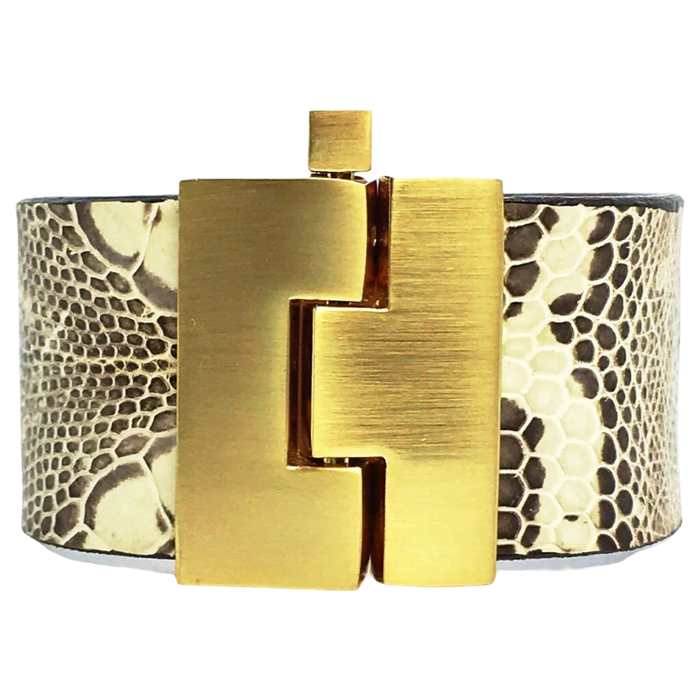 Bracelet with gold clasp and snake skin pattern on a white background
