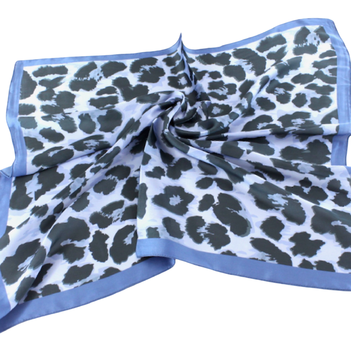 Pale blue square scarf with dark leopard spots and a contrasting deeper blue border.