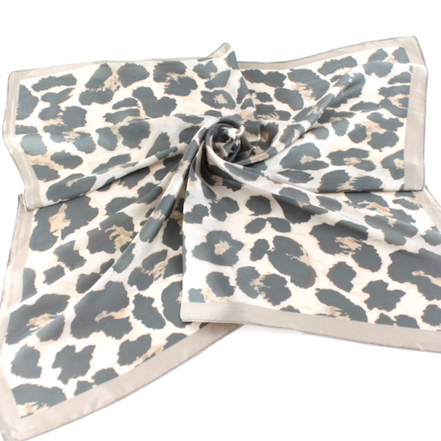 Cream square scarf with muted gray leopard spots and a solid sand-colored border.