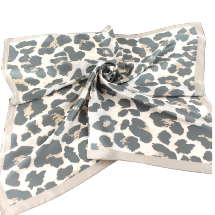 Cream square scarf with muted gray leopard spots and a solid sand-colored border.