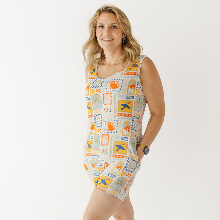 Woman wearing a sleeveless dress with colorful pattern on a white background