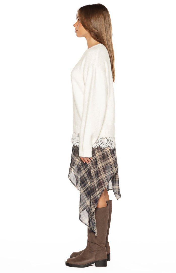 Side view of the cream fluffy knit sweater showing the relaxed fit and white lace trim at the hem
