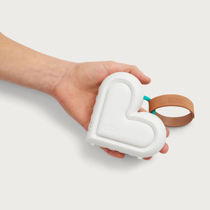 White heart-shaped teether with brown loop for Love to Dream Sleep Machine and Toshi Baby Romper
