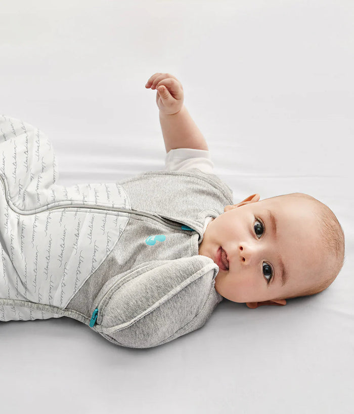 Baby in gray and white swaddle from the Love To Dream Swaddle Up Transition Bag 2.5 TOG, perfect for toshi baby romper and baby strollers