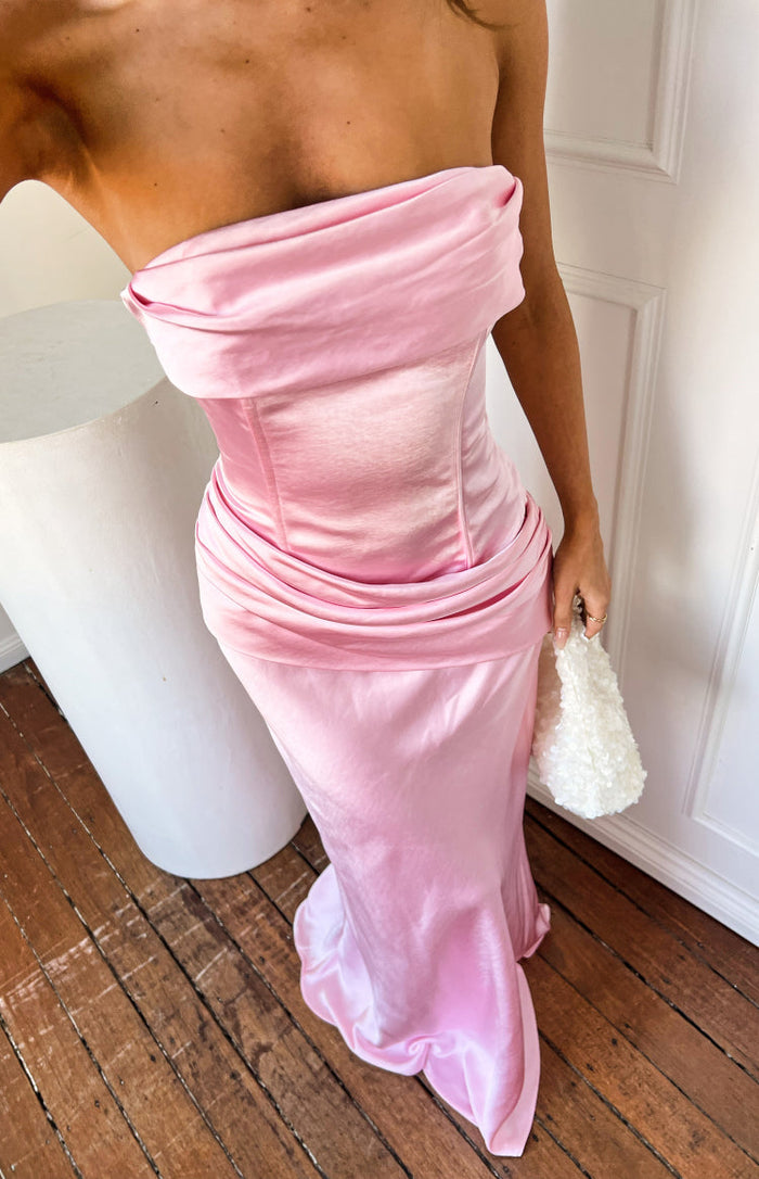 Pink satin strapless maxi dress with a draped neckline, corset bodice, and ruched waist detail