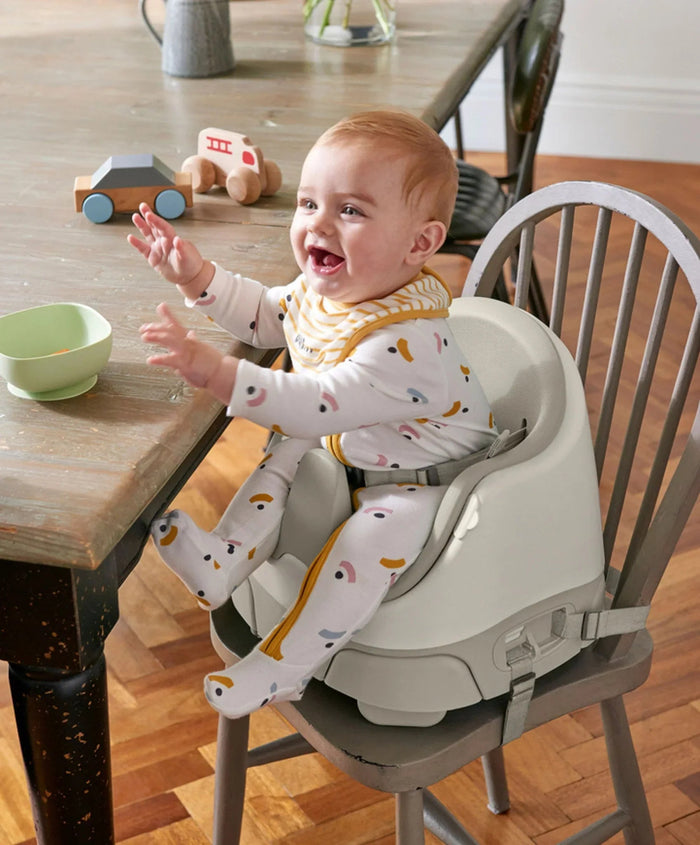 Baby sitting in a versatile booster seat from Mamas & Papas Bug 3-in-1 Floor series