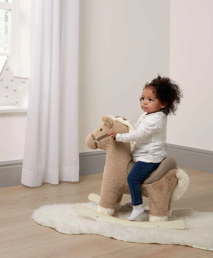Child riding a plush Mamas & Papas Rocking Animal Bugsy with Toshi Baby Romper Eva