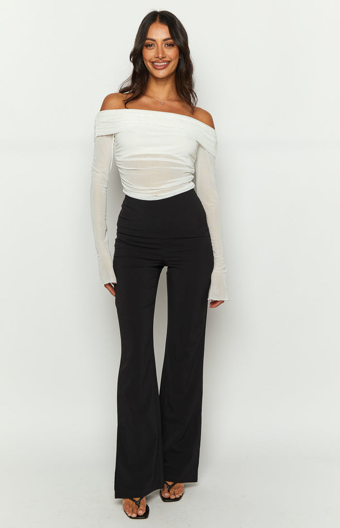 Black high-waisted flared pants with a smooth fabric and full length