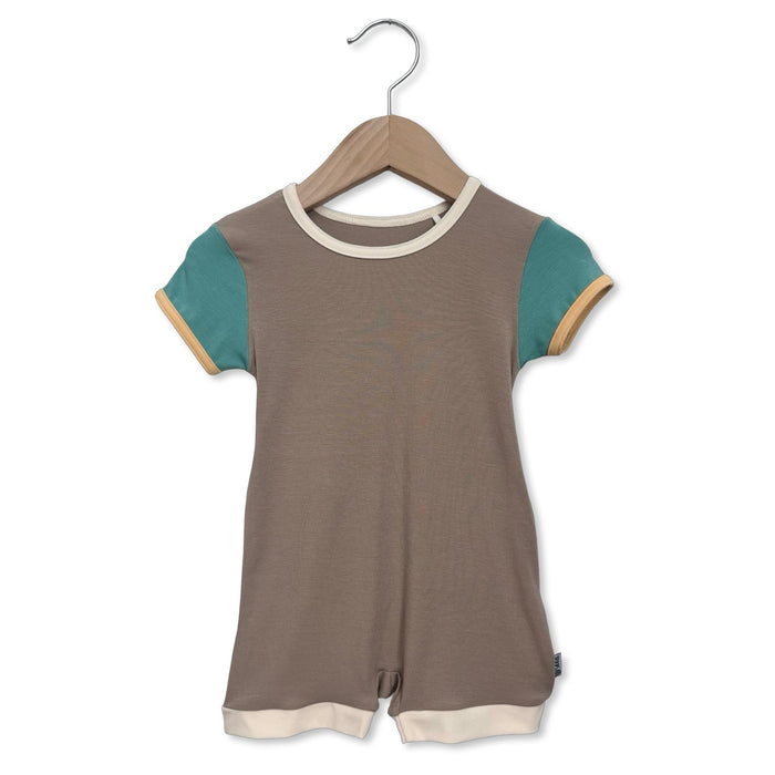 Brown and teal romper on a hanger against a white background